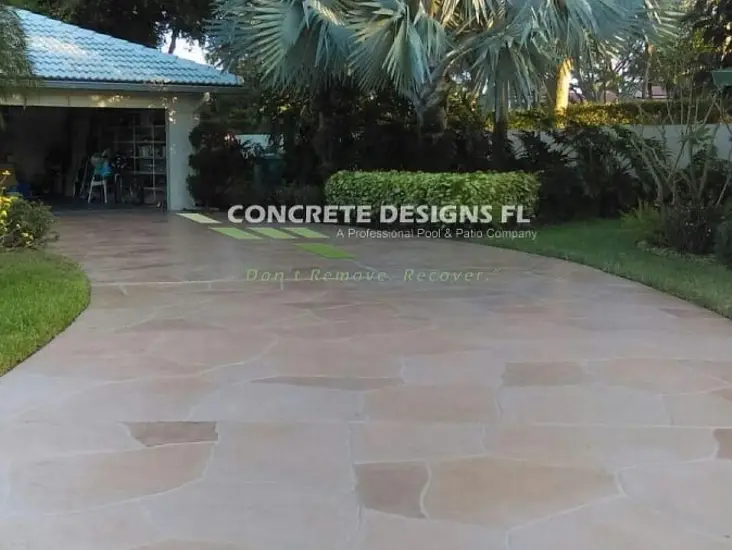 Concrete driveway leading toward a home entrance